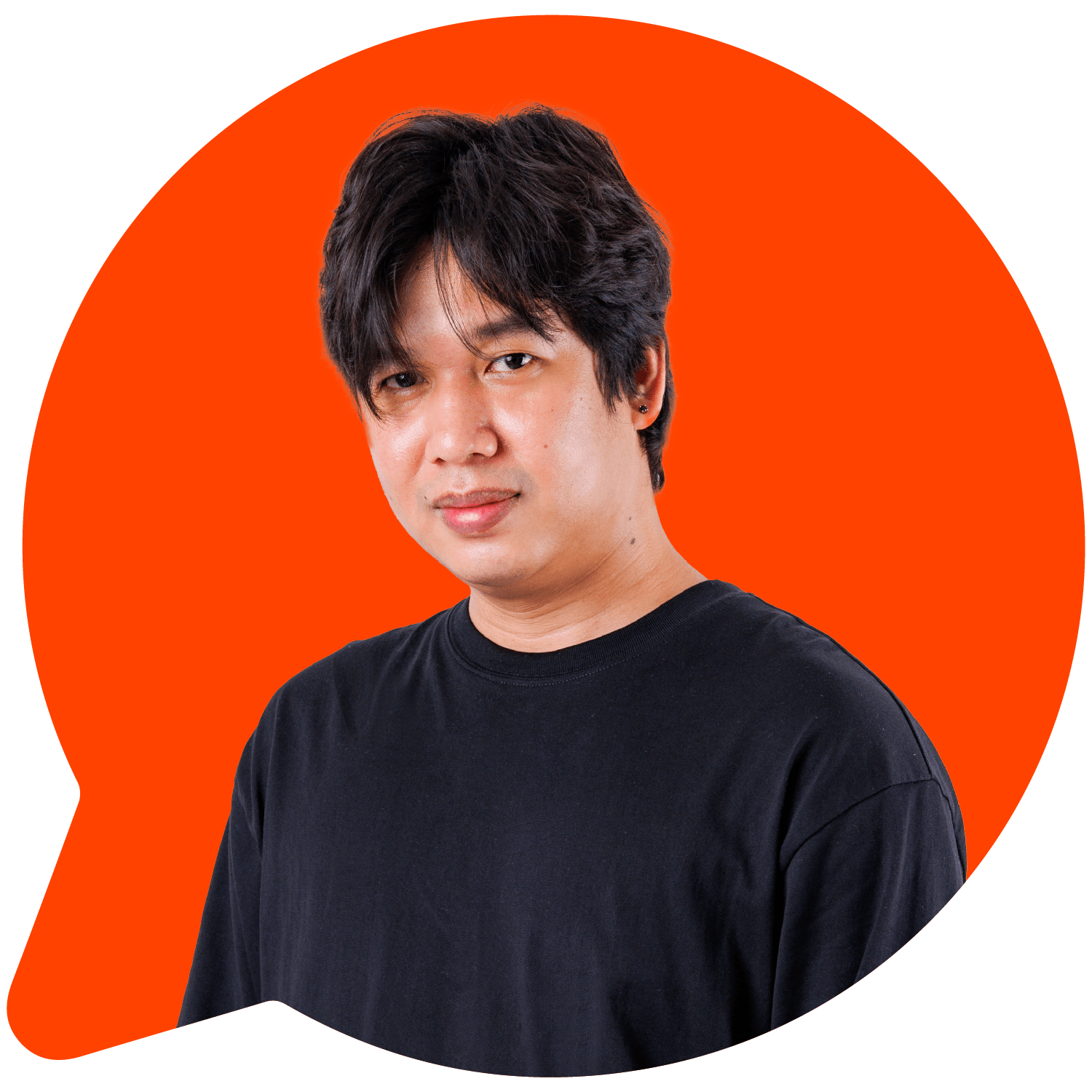 A man in a black shirt standing against an orange background.