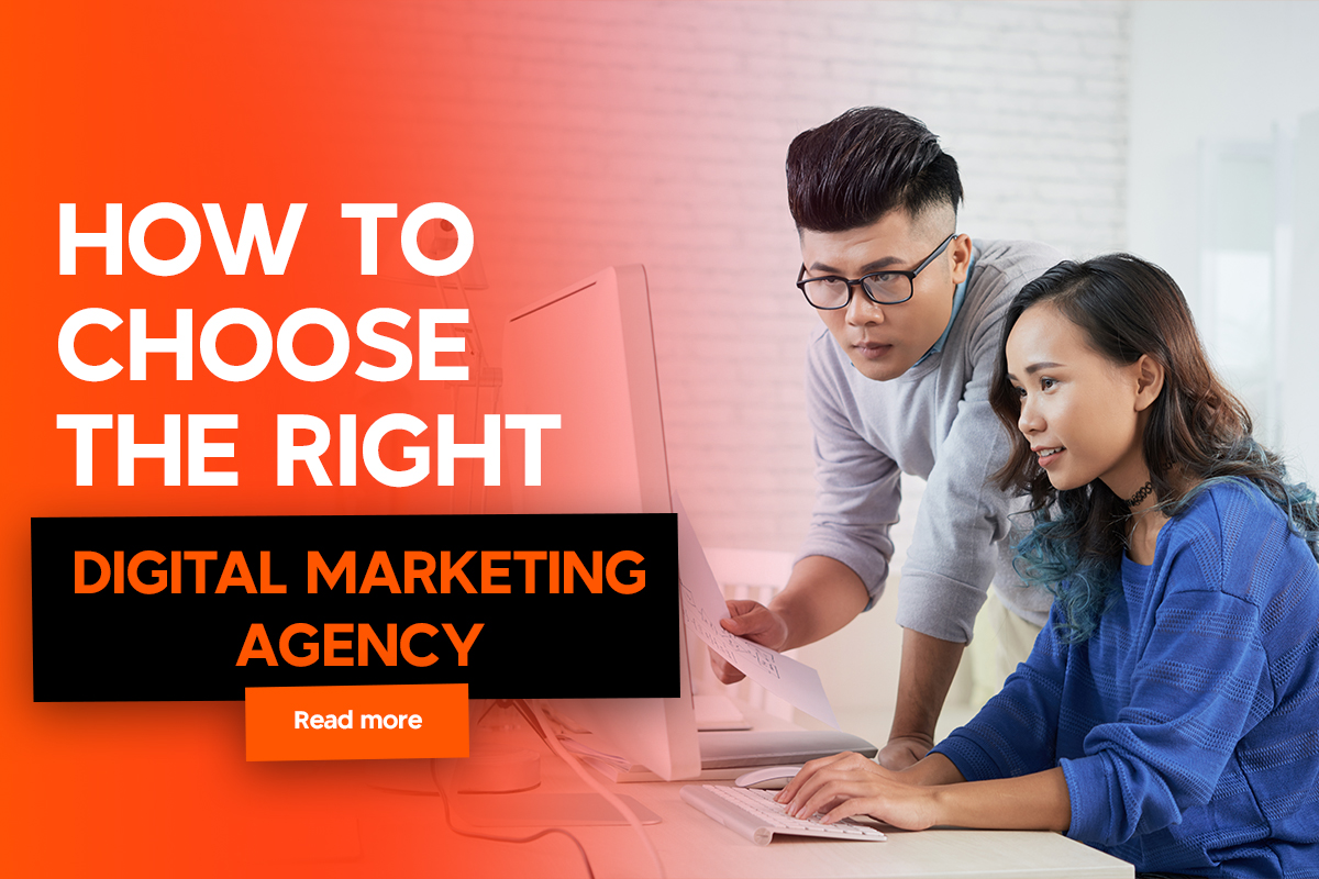 Two colleagues collaborate at a desk, focusing intently on a computer screen. The atmosphere is professional yet relaxed.